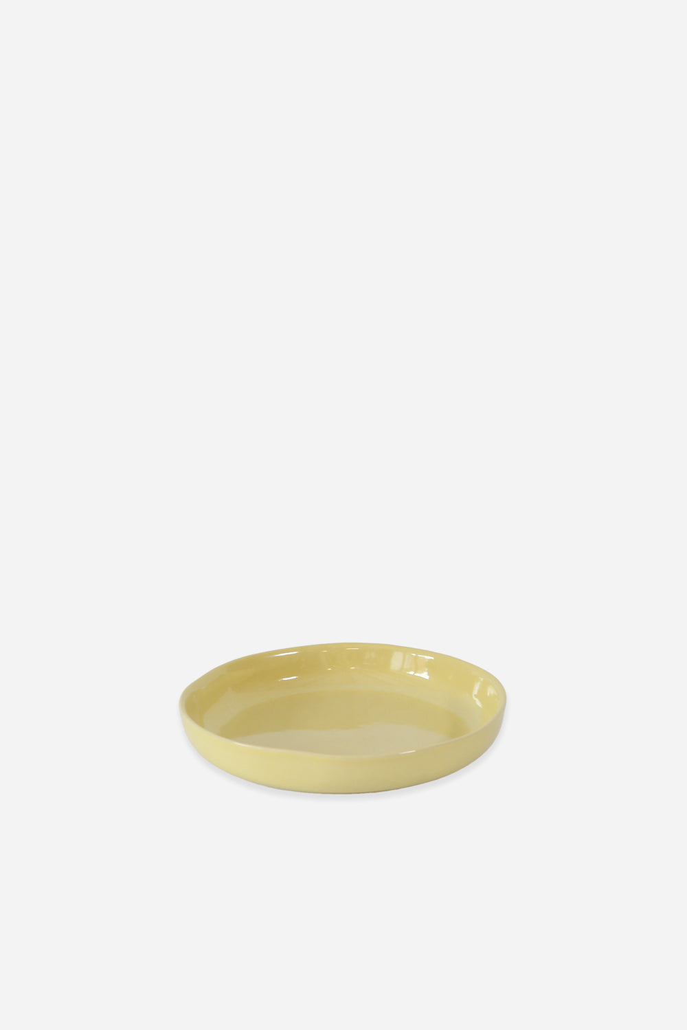Yellow ceramic bowl on a white background