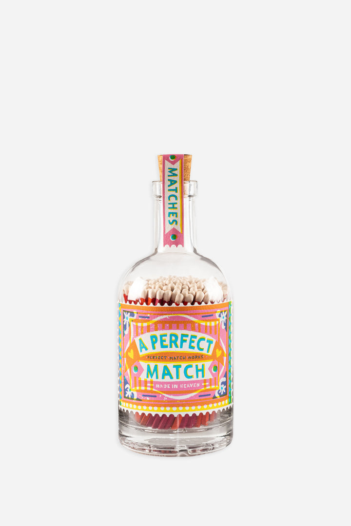 glass bottle filled with matches with decorative perfect match label