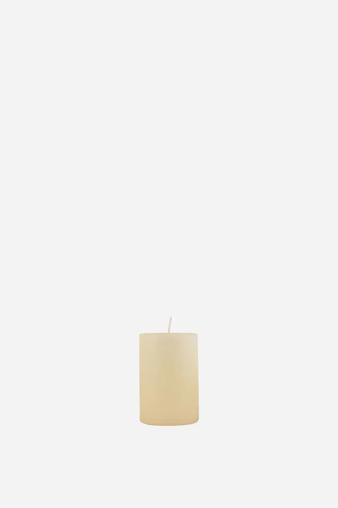 Beige candle on a white background