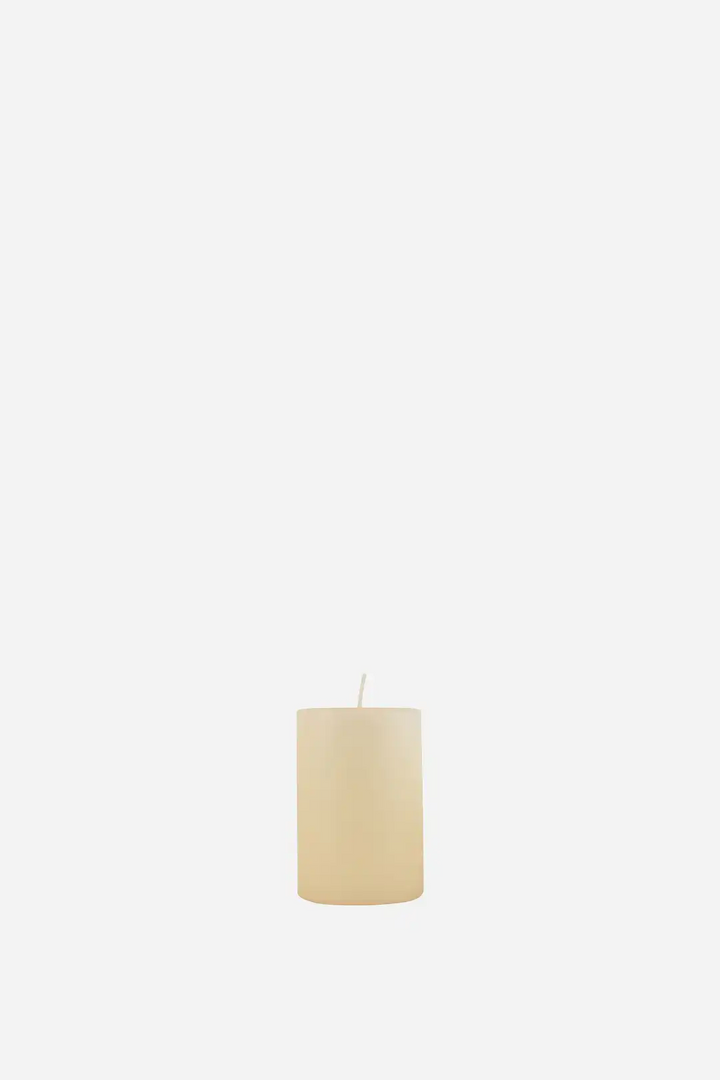 Beige candle on a white background
