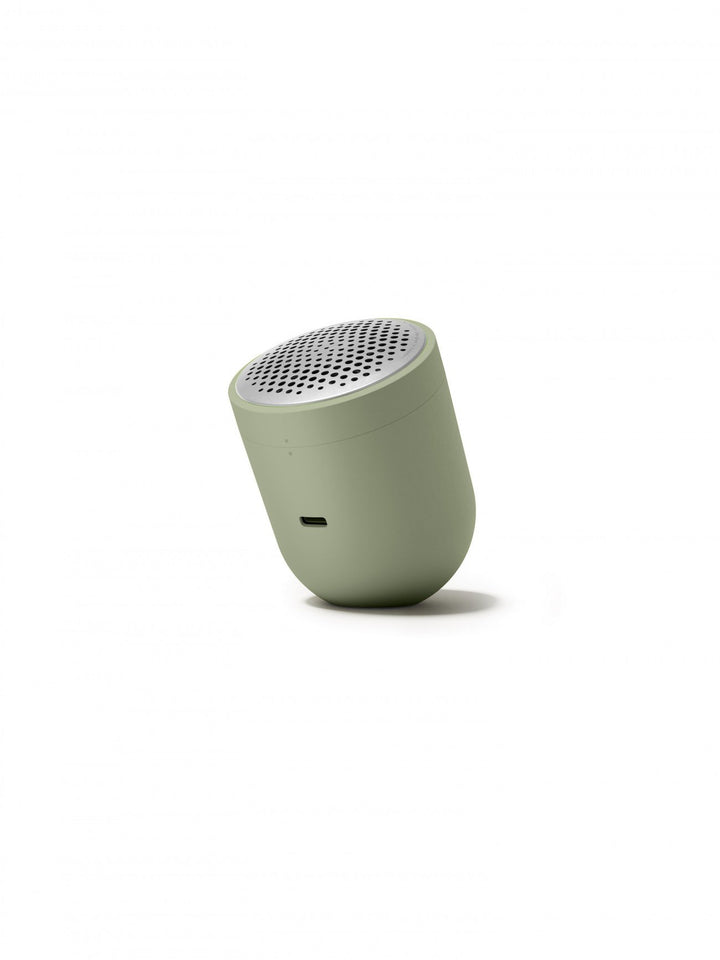Small green fabric shaver on a white background