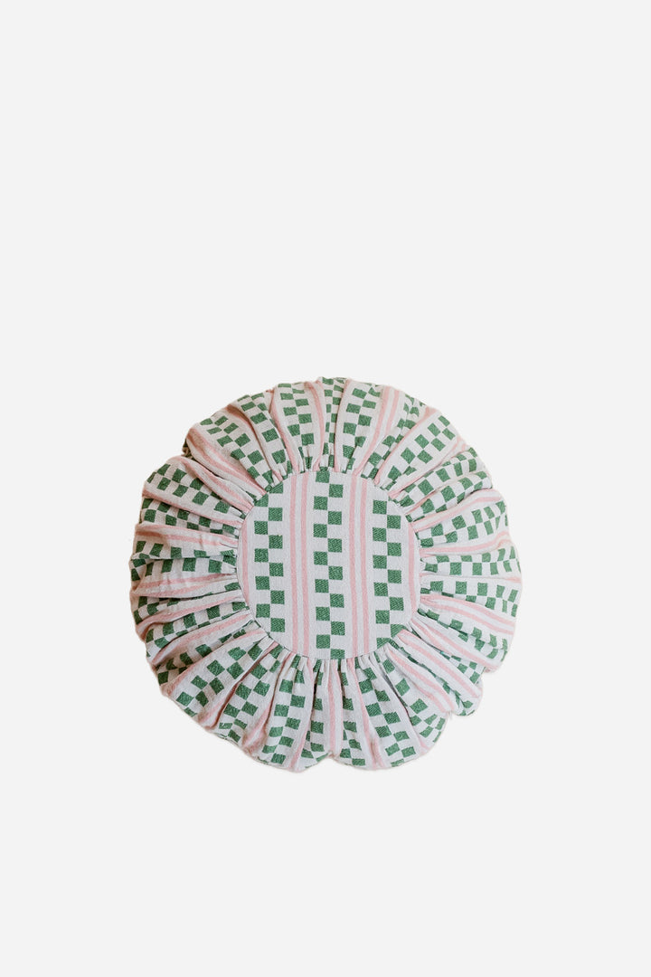 green and pink patterned circular woven cushion