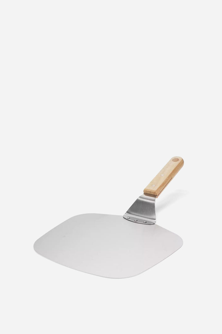 Metal pizza peel with a wooden handle on a white background