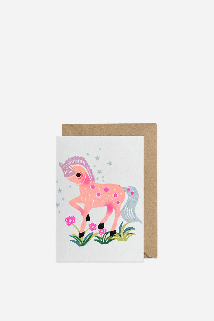 Greeting card with a pink unicorn illustration on a white background