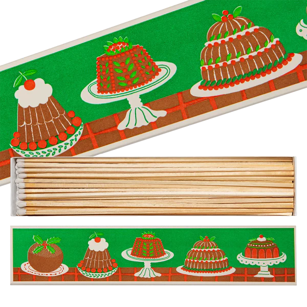 Matchbox with Christmas pudding design and wooden matches on a white background