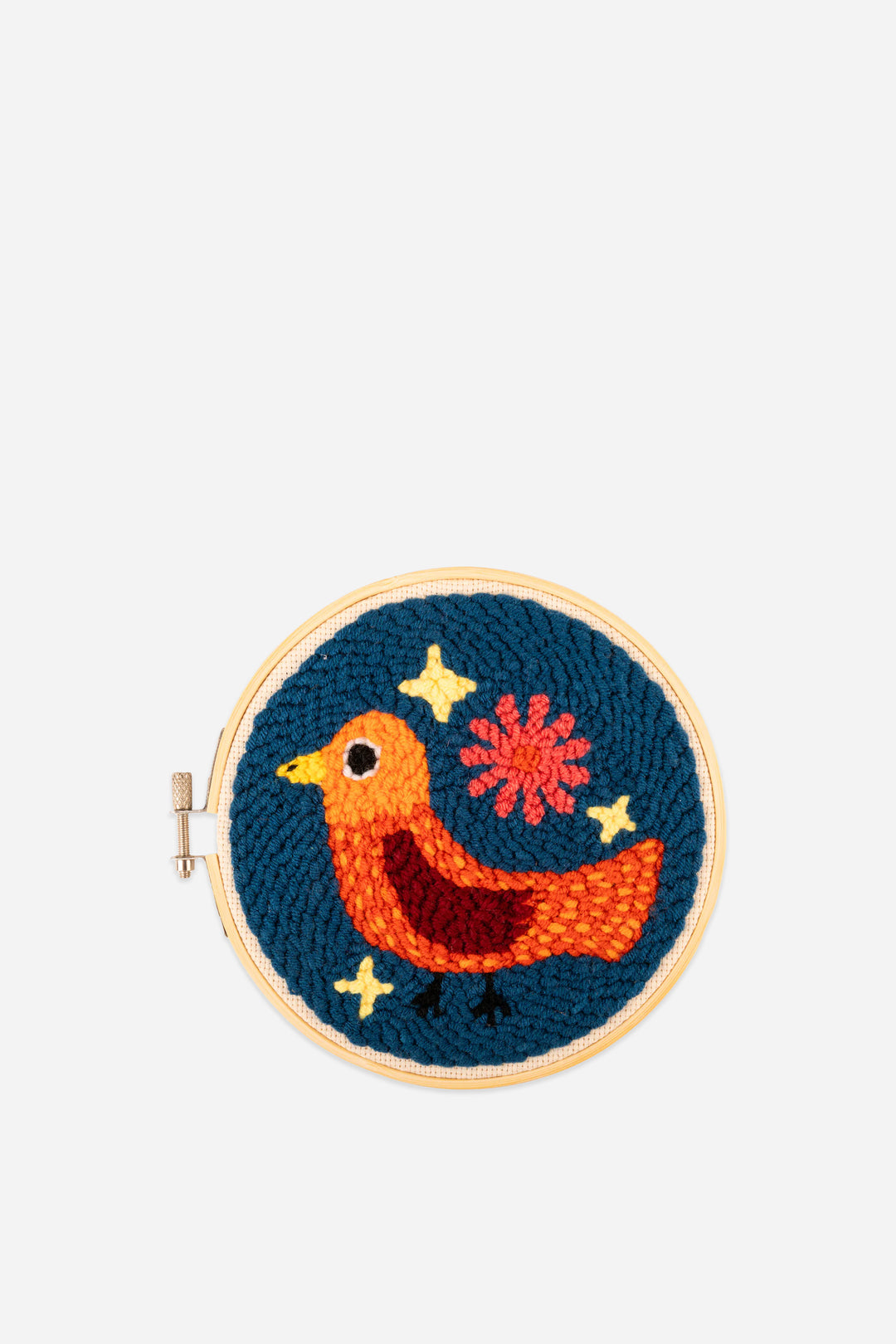 Embroidered hoop with a colorful bird design on a blue background