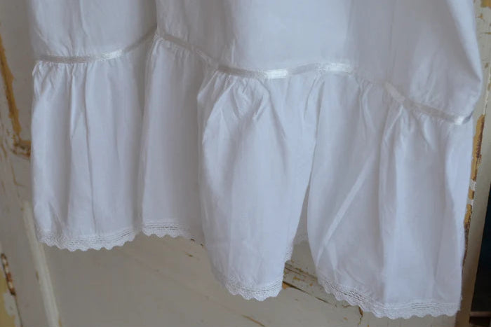 White lace-trimmed dress on a white background