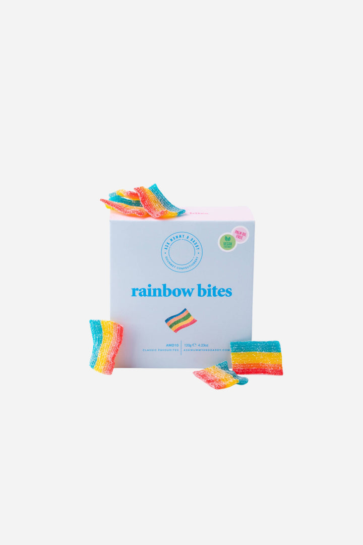 Box of rainbow bites with colorful snack sticks on a white background