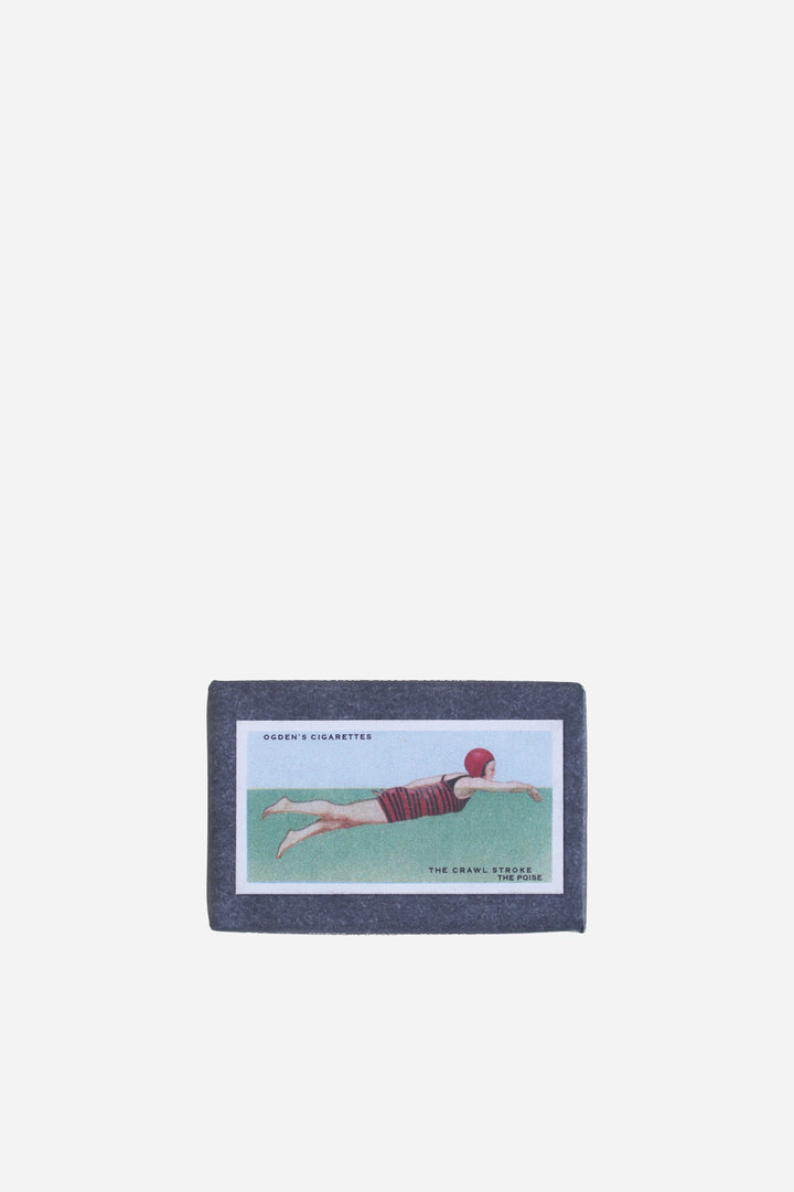 retro olive soap bar with vintage cigarette packaging swimming