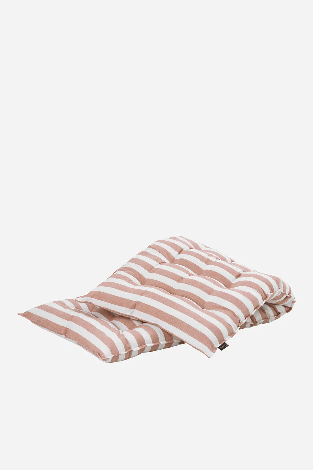 Folded pink and white striped mattress on a white background