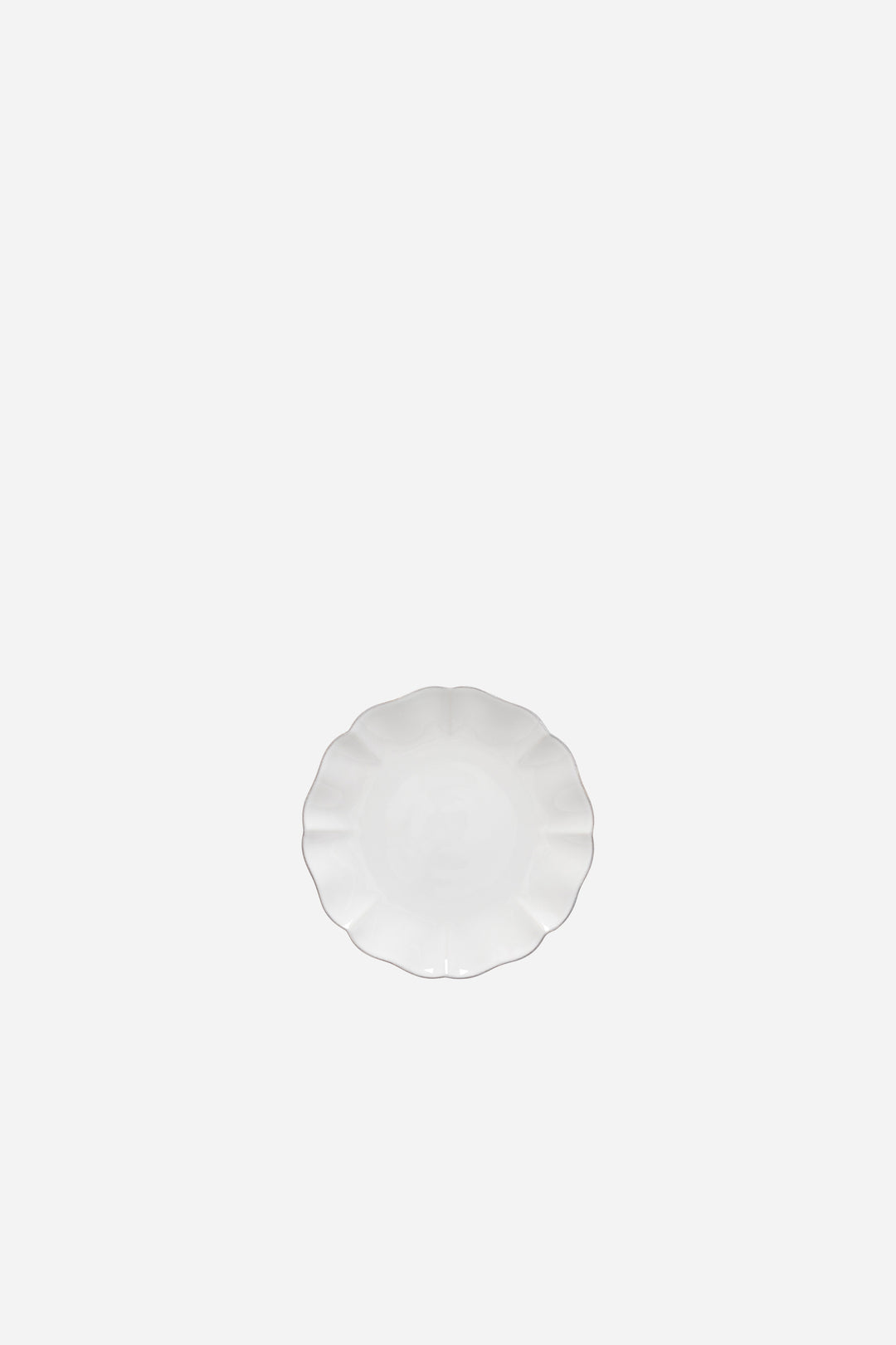 Round white appetizer plate on a white background