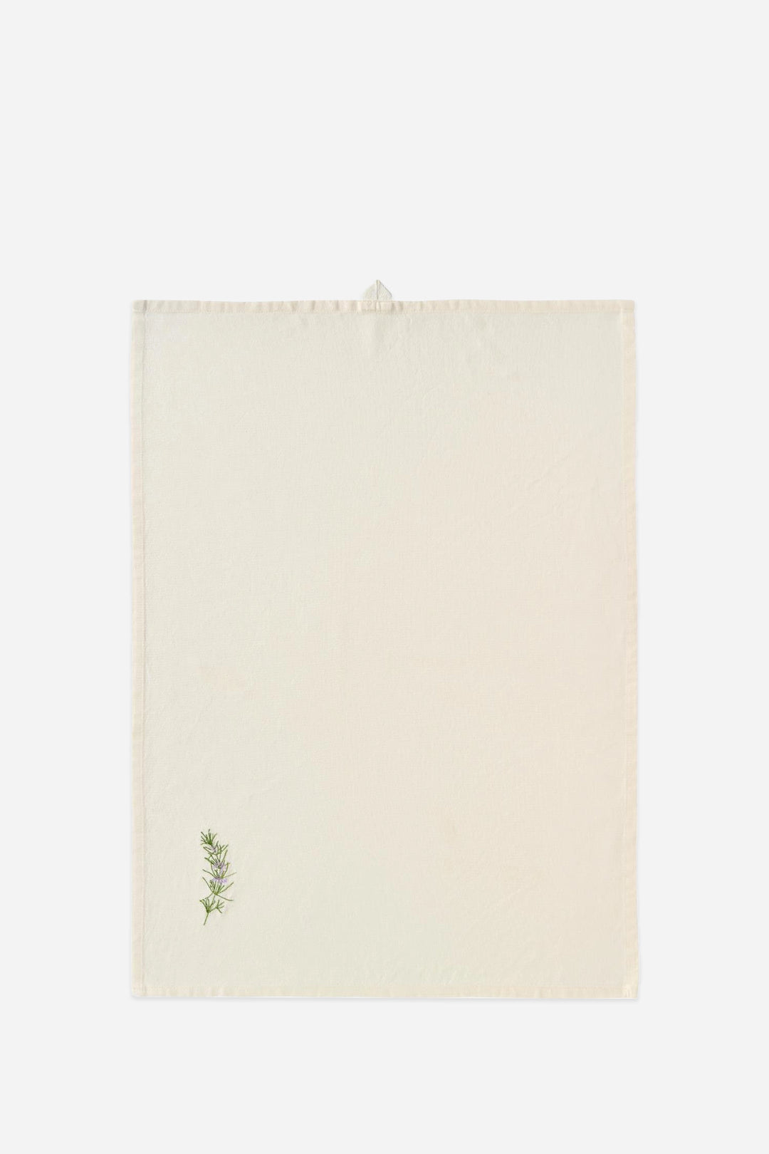 Beige towel with a small green leaf design on a white background
