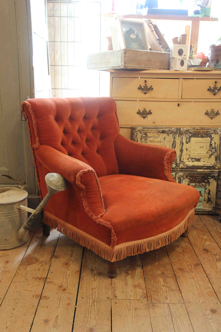 rust velvet armchair with fringing