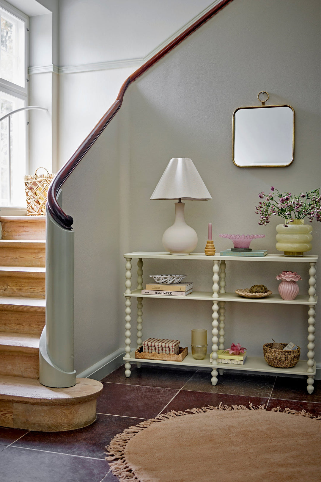 white console table against a wall, featuring decorative items.