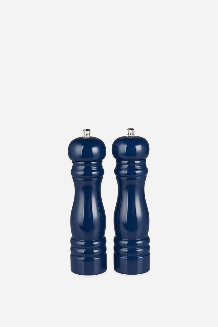 Two navy blue salt and pepper shakers on a white background