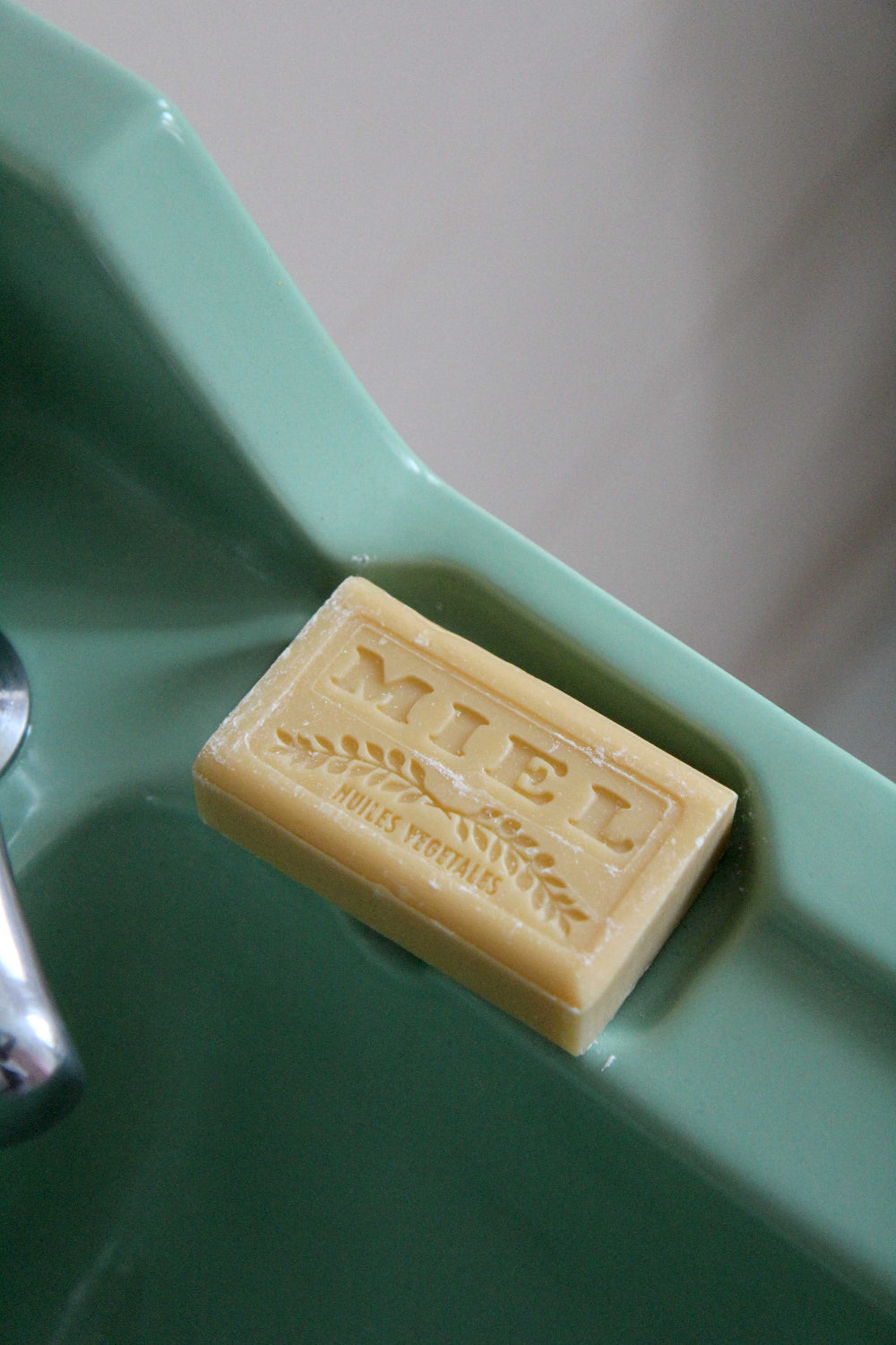 savon de marseille soap bar miel on vintage green sink