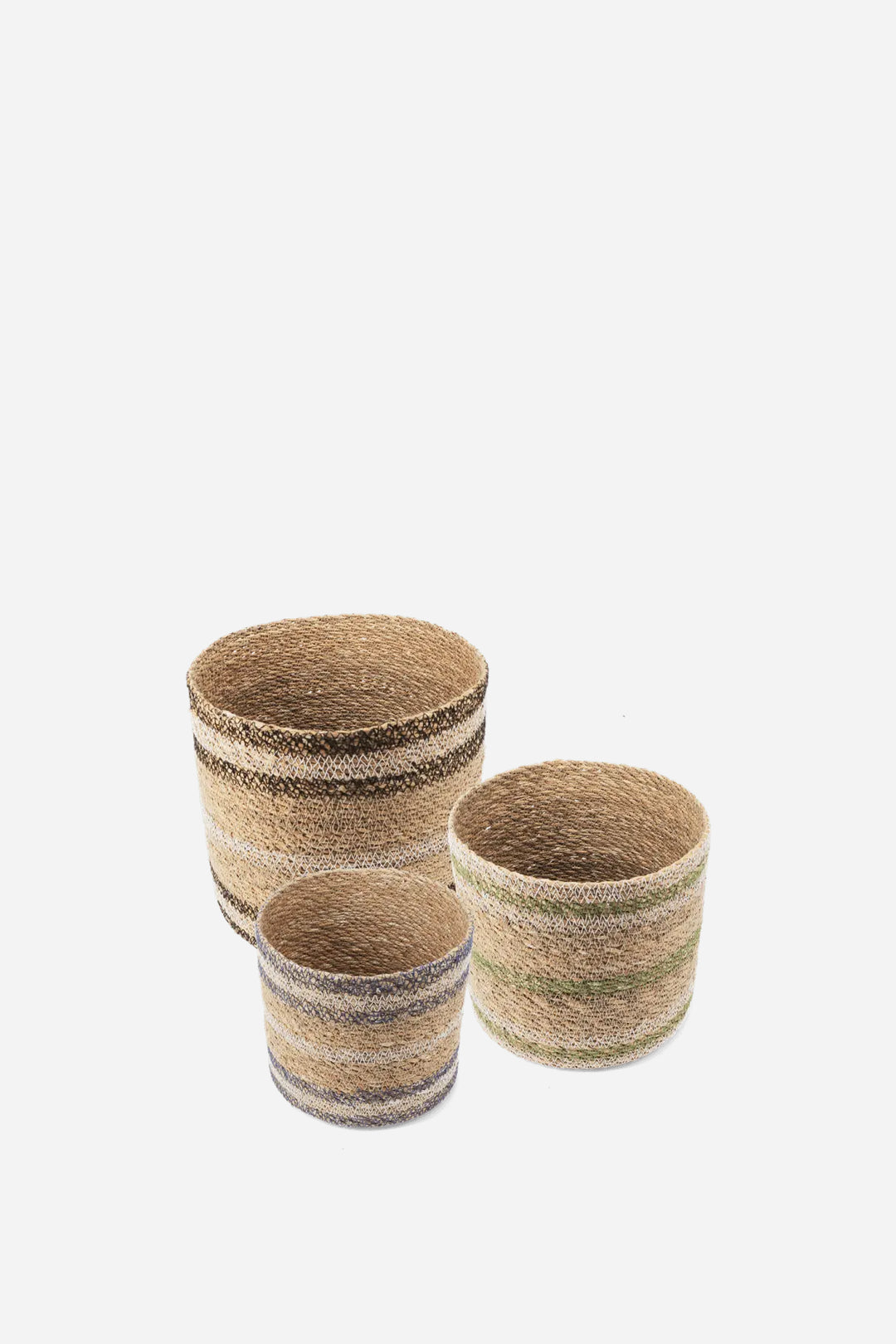 Three woven storage baskets in different sizes, made from natural straw with horizontal stripes in beige, brown, and muted green, set against a plain light gray background.