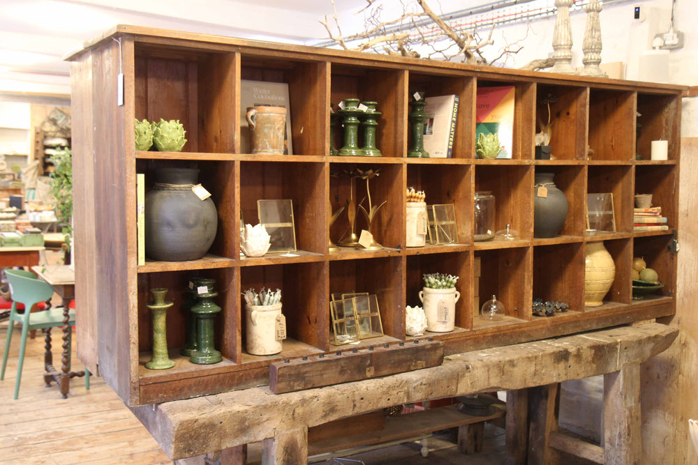 Wooden shelf with various decorative items in a room setting