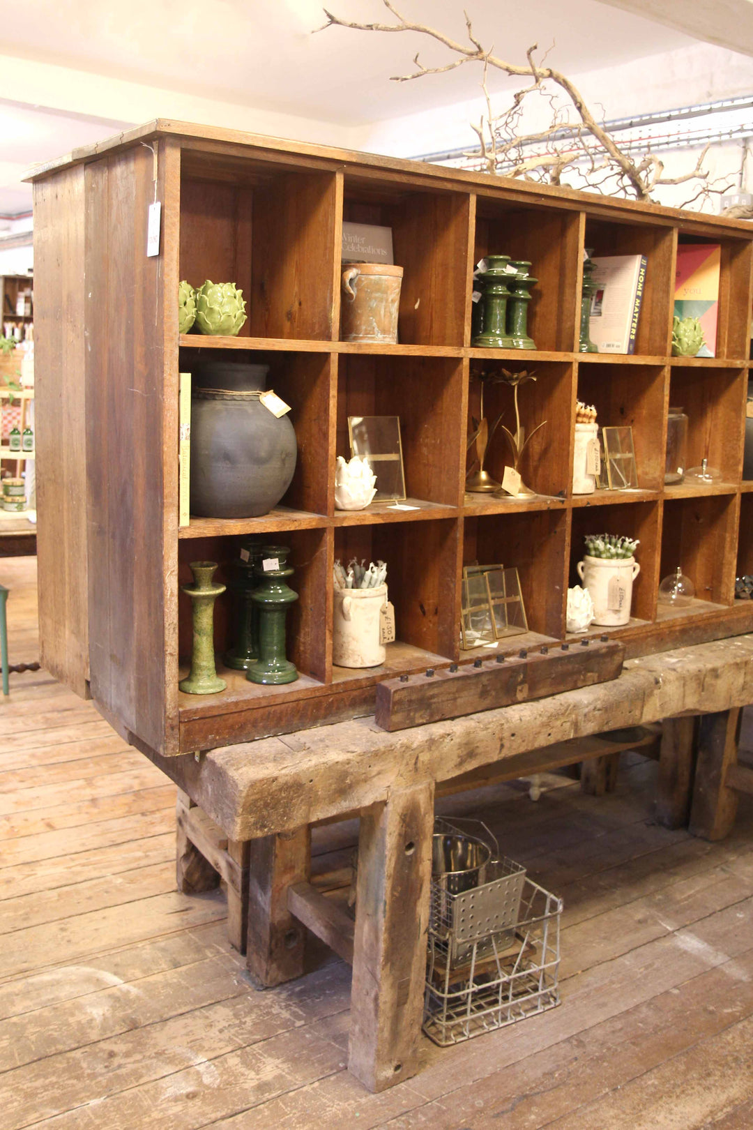 Wooden shelf with various decorative items on a wooden floor