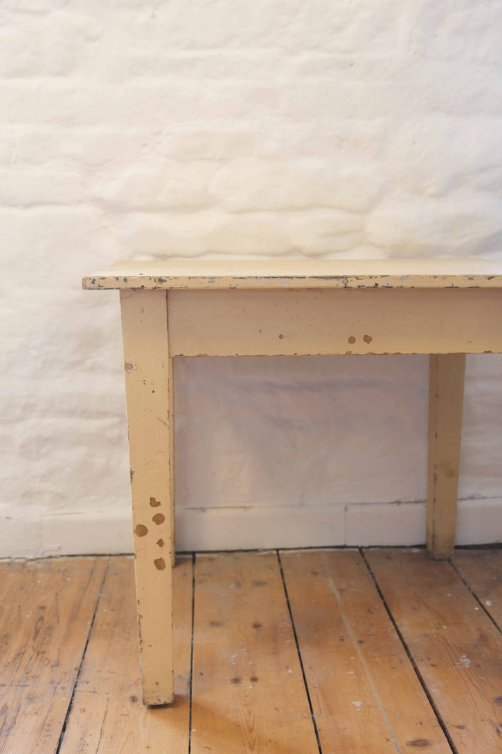 Wooden table against a textured white wall