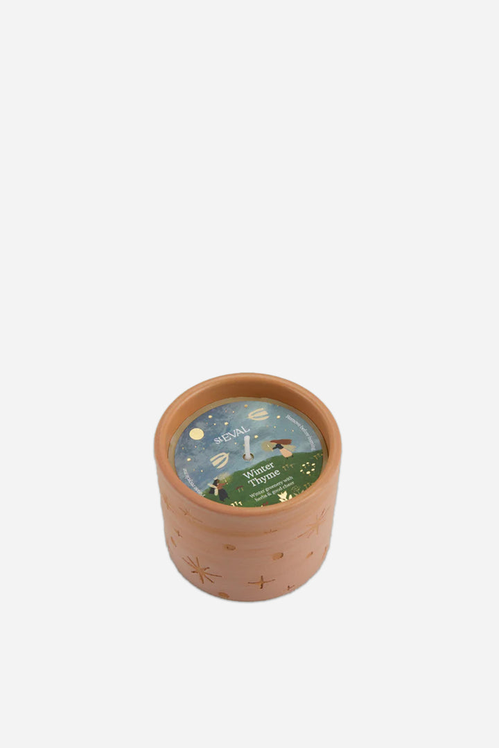 Ceramic winter thyme candle with a lid featuring illustrations on a white background