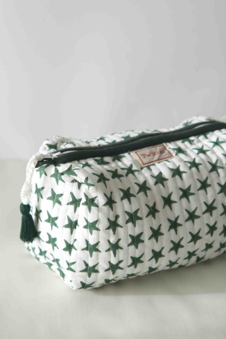 Fabric pouch with green star pattern on a light gray background