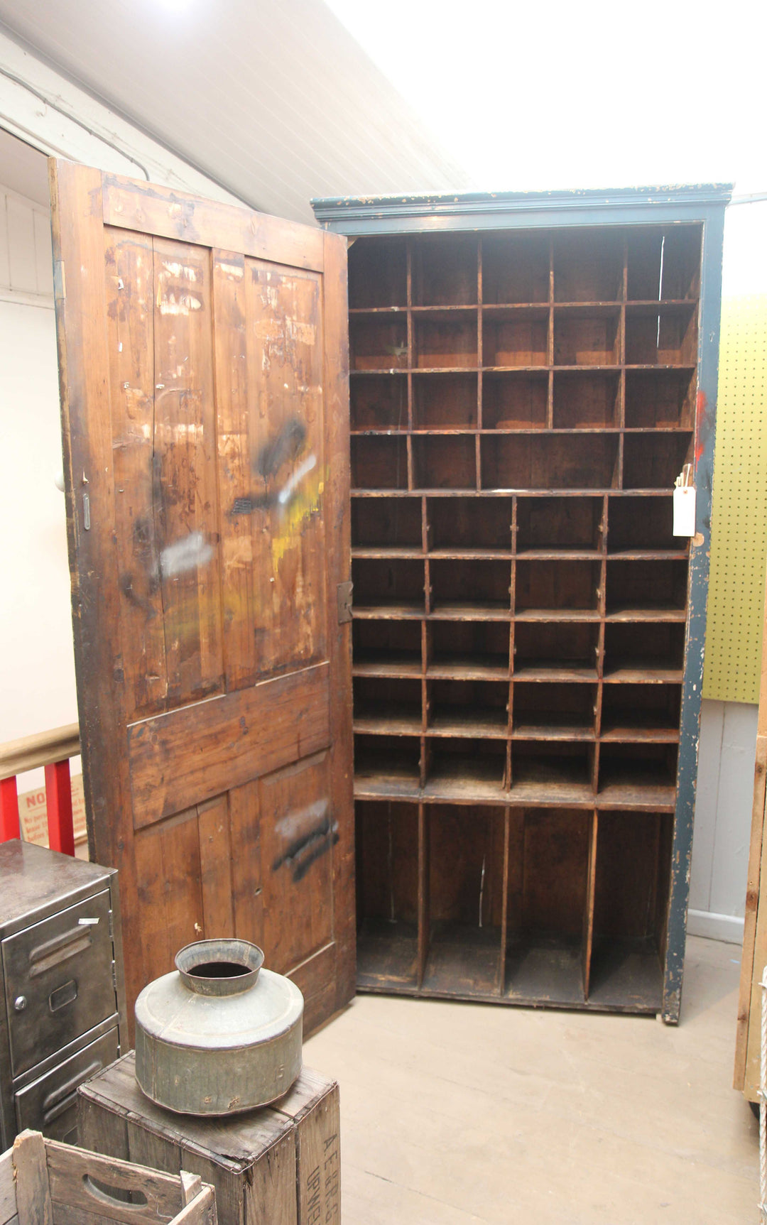 inside of vintage tall cupboard with wooden pigeon hole compartments