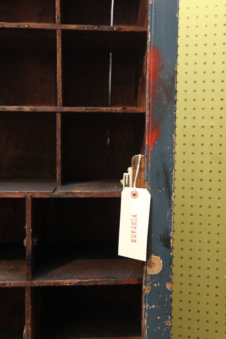 inside of vintage tall cupboard with wooden pigeon hole compartments