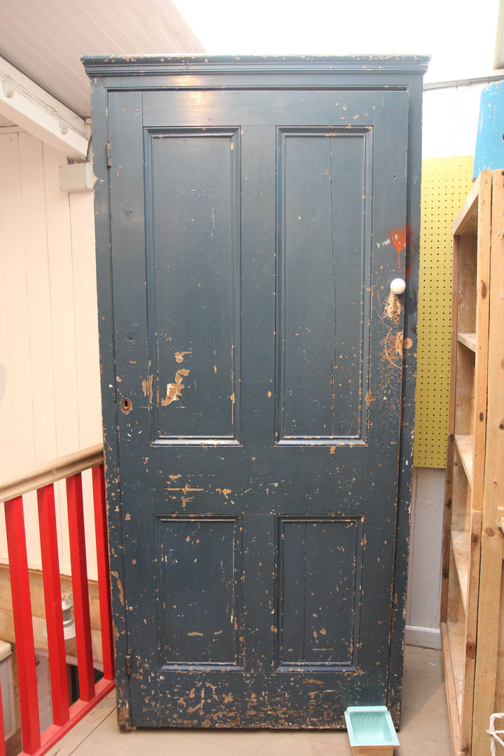 dark blue vintage tall cupboard in chippy paint