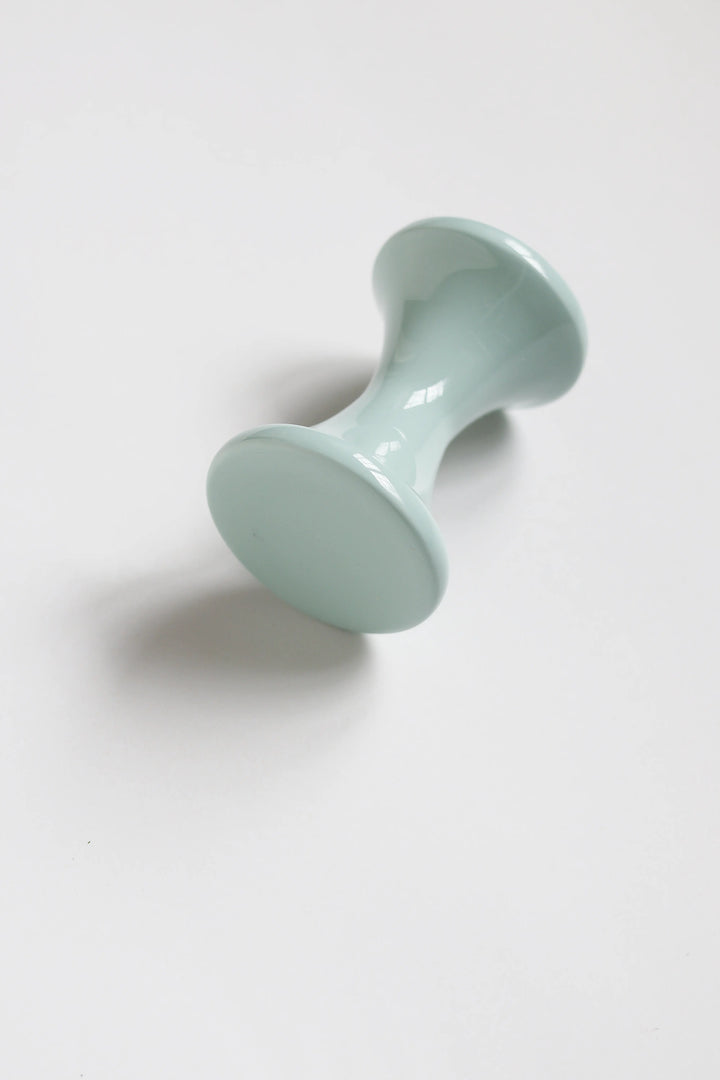 Light blue ceramic object on a white background