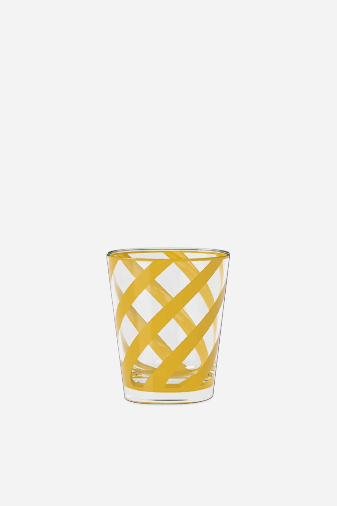 A clear glass shot glass featuring a yellow geometric lattice pattern, set against a solid light gray background.