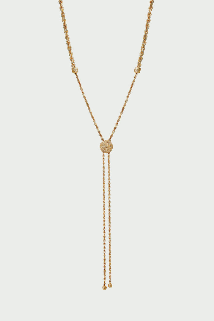 Gold necklace with a y-style clasp on a light gray background