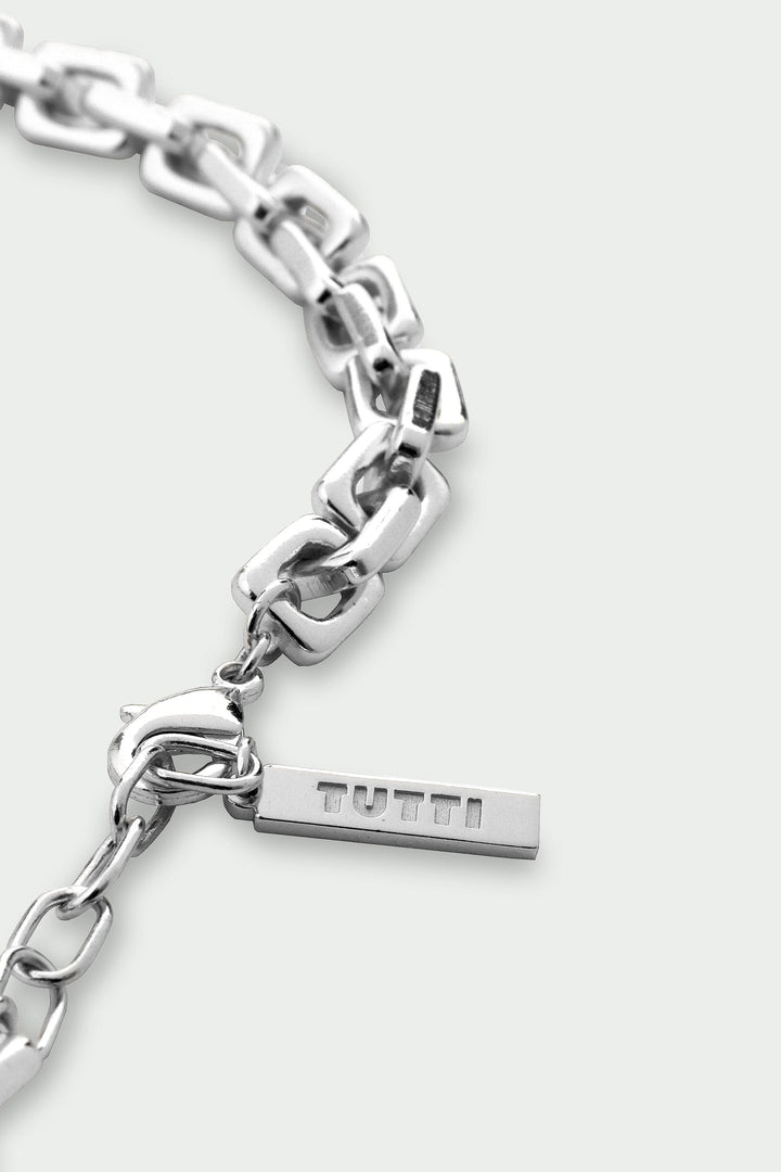 Silver chain bracelet with a TUTU tag on a white background