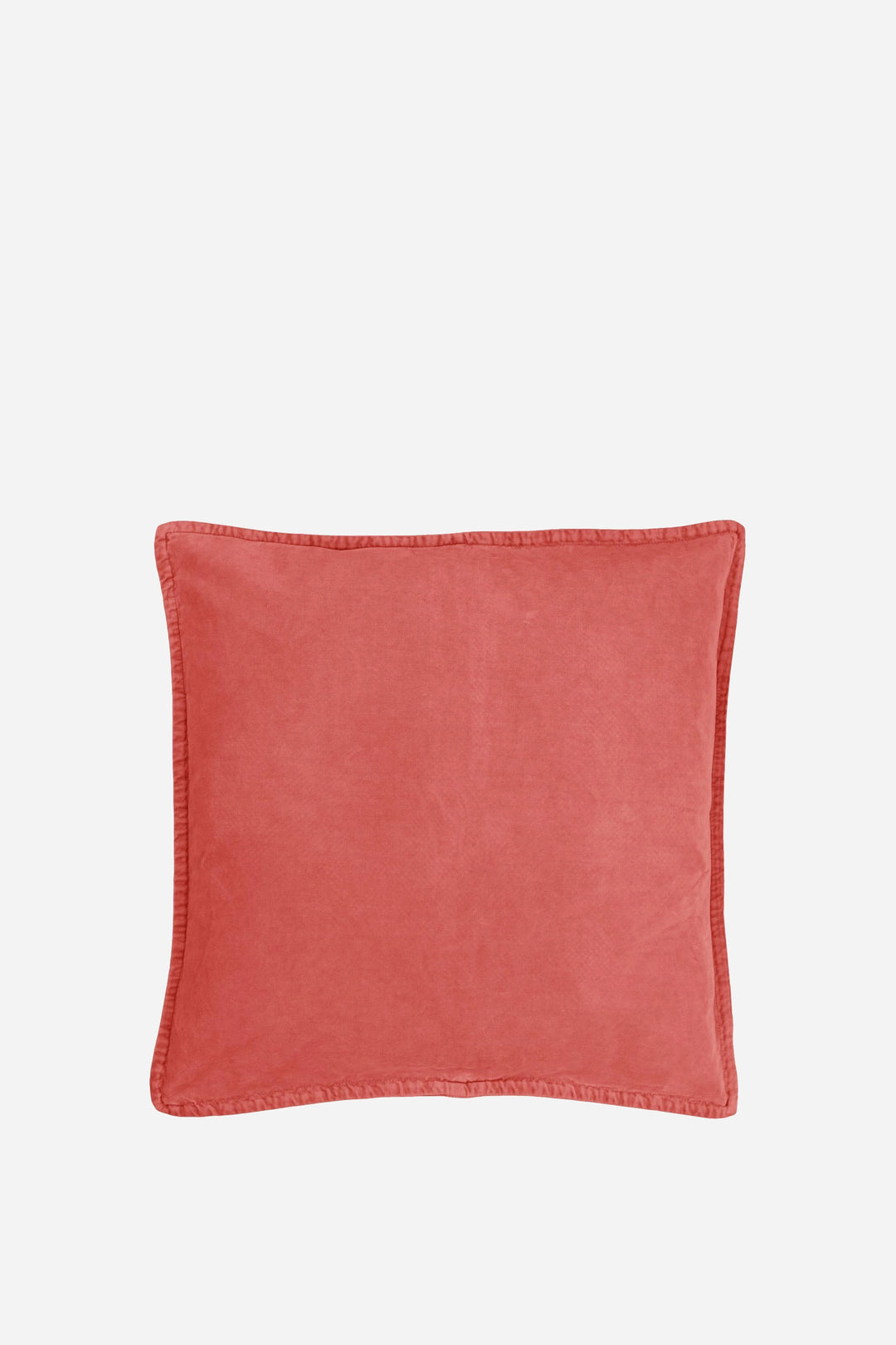 melon coloured cushion on a light beige background