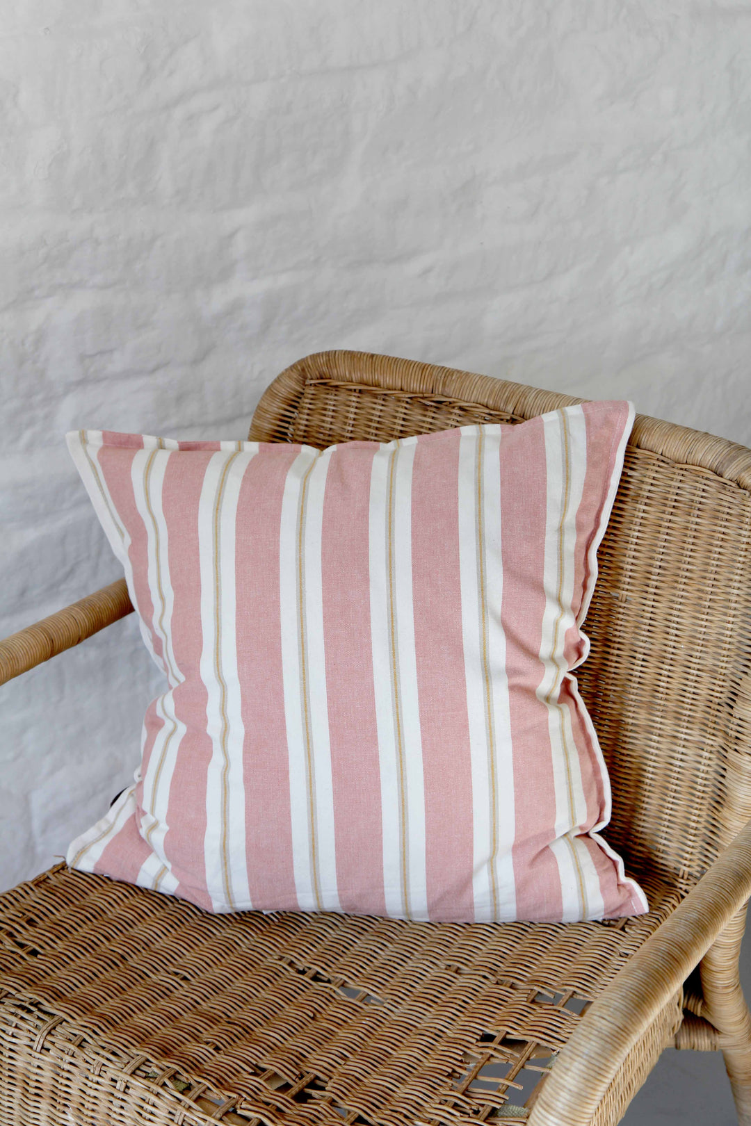 rose striped cotton cushion on rattan chair