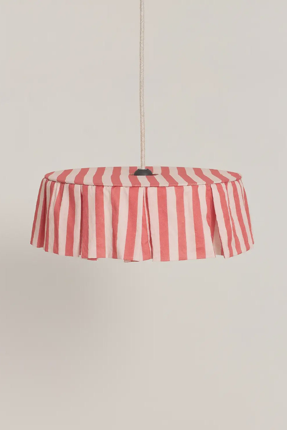 Red and white striped pendant light on a beige background