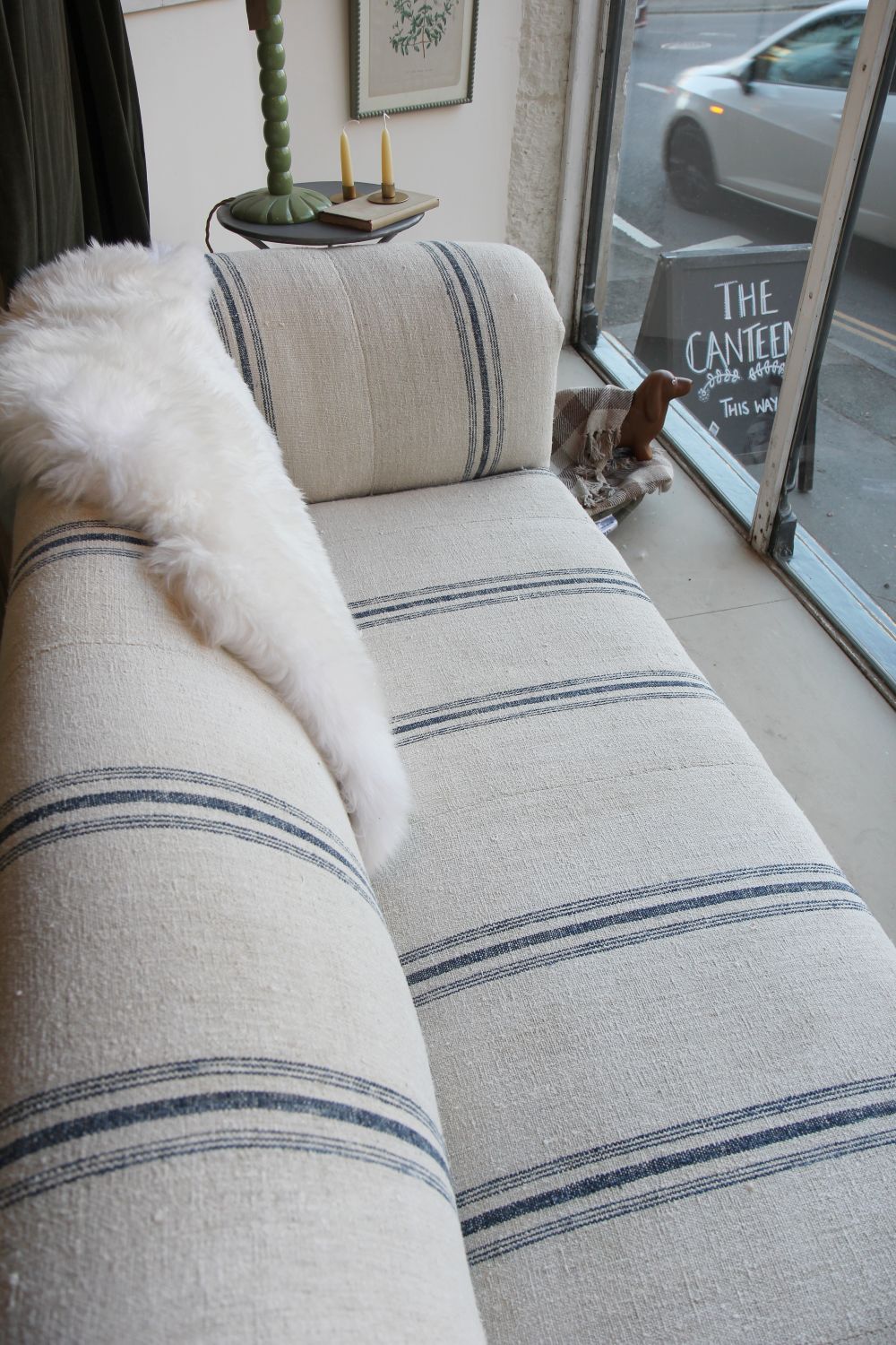 vintage chesterfield sofa upholstered in grain sack with blue stripe