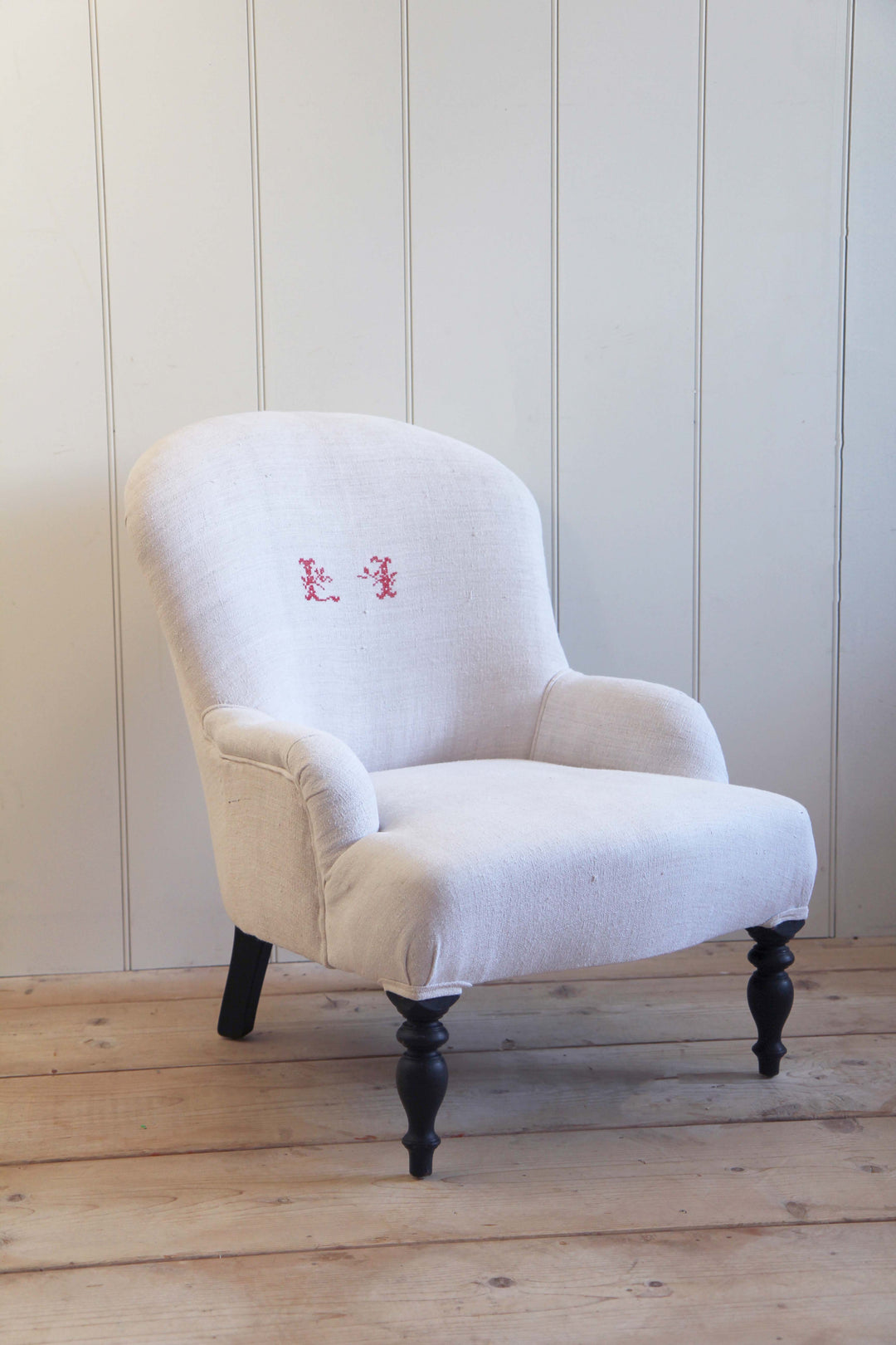 vintage grain sack upholstered armchair with red monogrammed initials