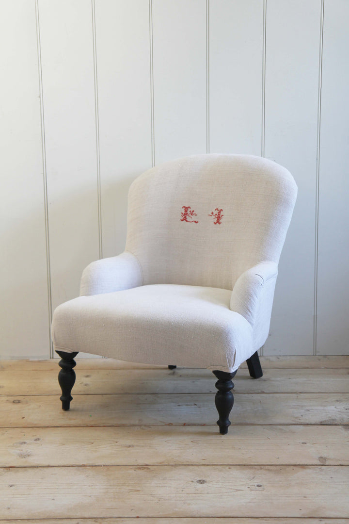 vintage grain sack upholstered armchair with red monogrammed initials