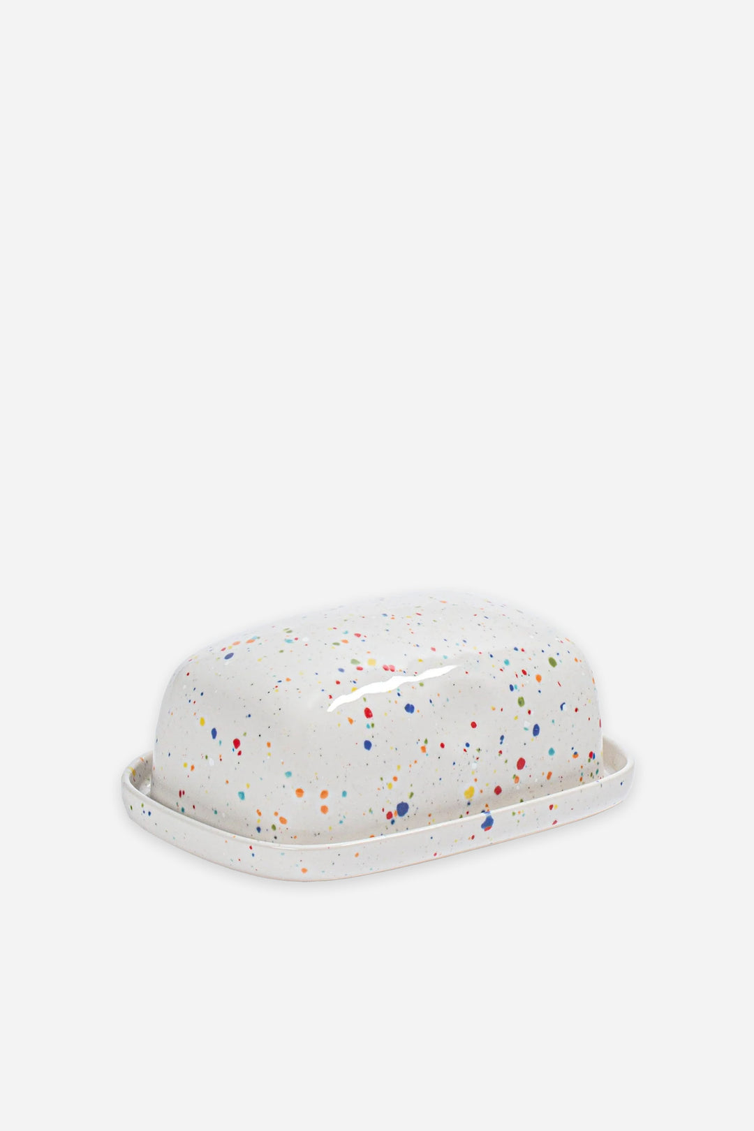 White butter dish with colorful speckles on a white background