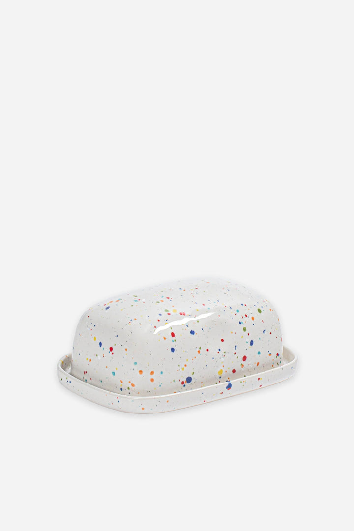 White butter dish with colorful speckles on a white background