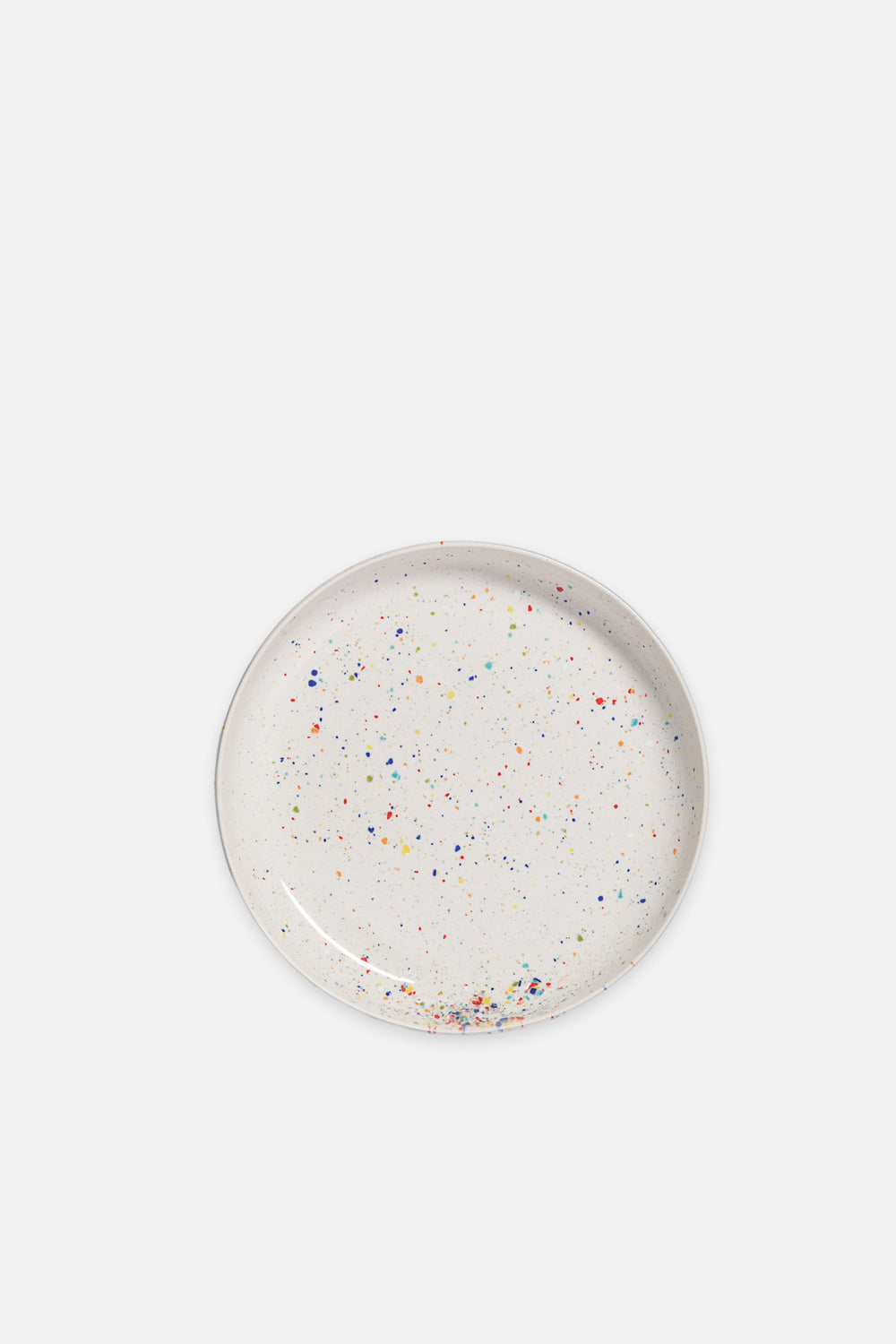 Round speckled ceramic plate on a white background