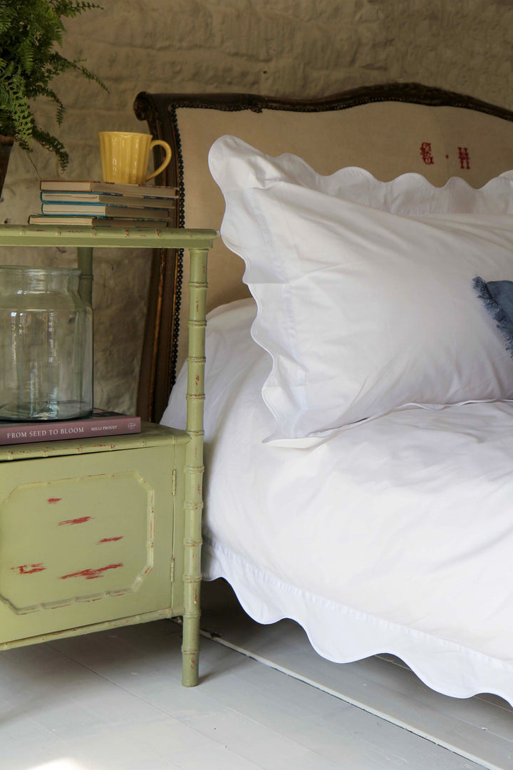 Bedroom with White duvet and pillowcase with a scalloped wavy edge