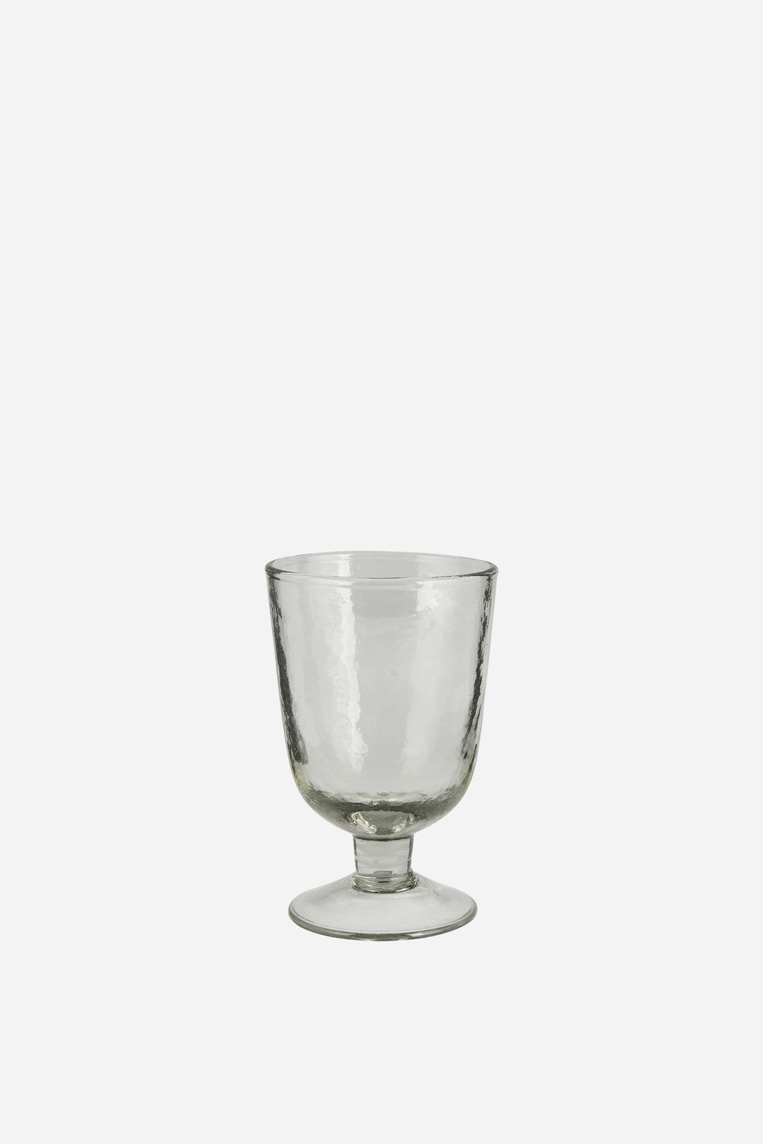 Clear glass goblet on a white background