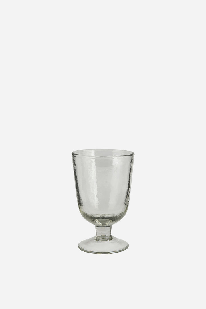 Clear glass goblet on a white background