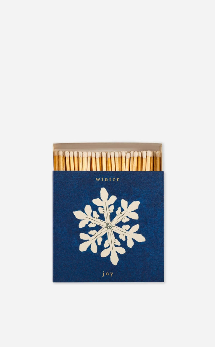 Matchbox with matches and a snowflake design on a white background