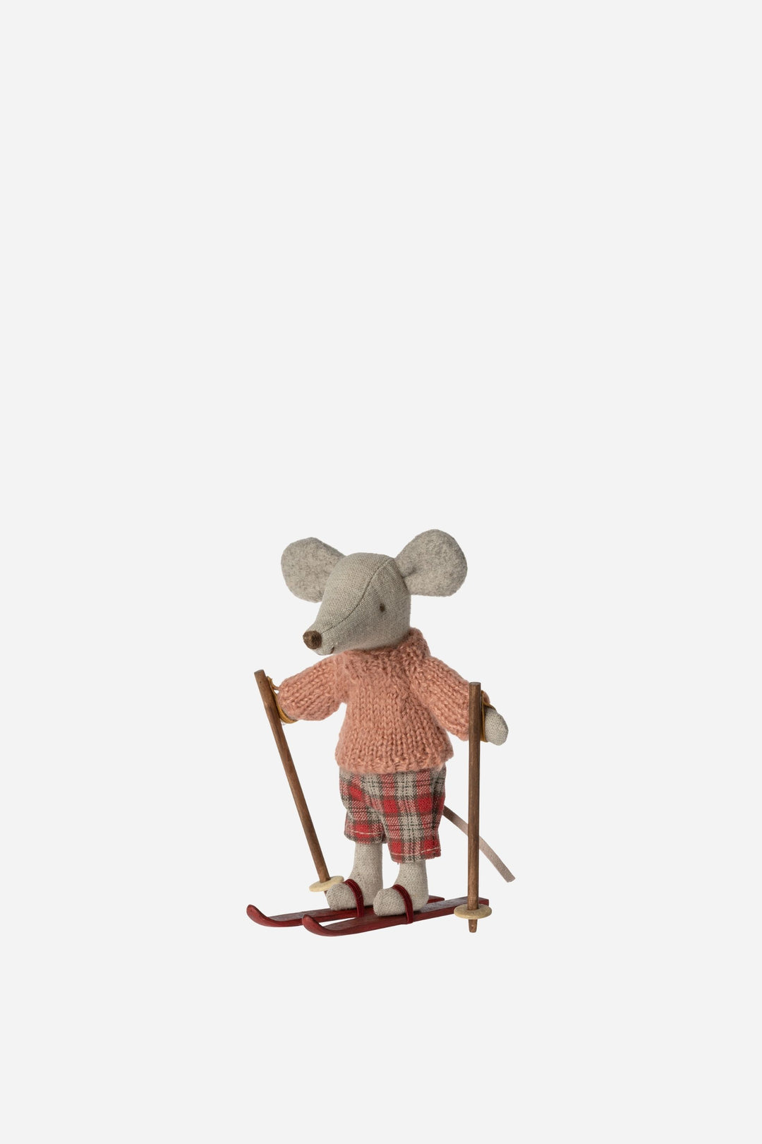 Stuffed toy mouse in a sweater and shorts with skis on a white background