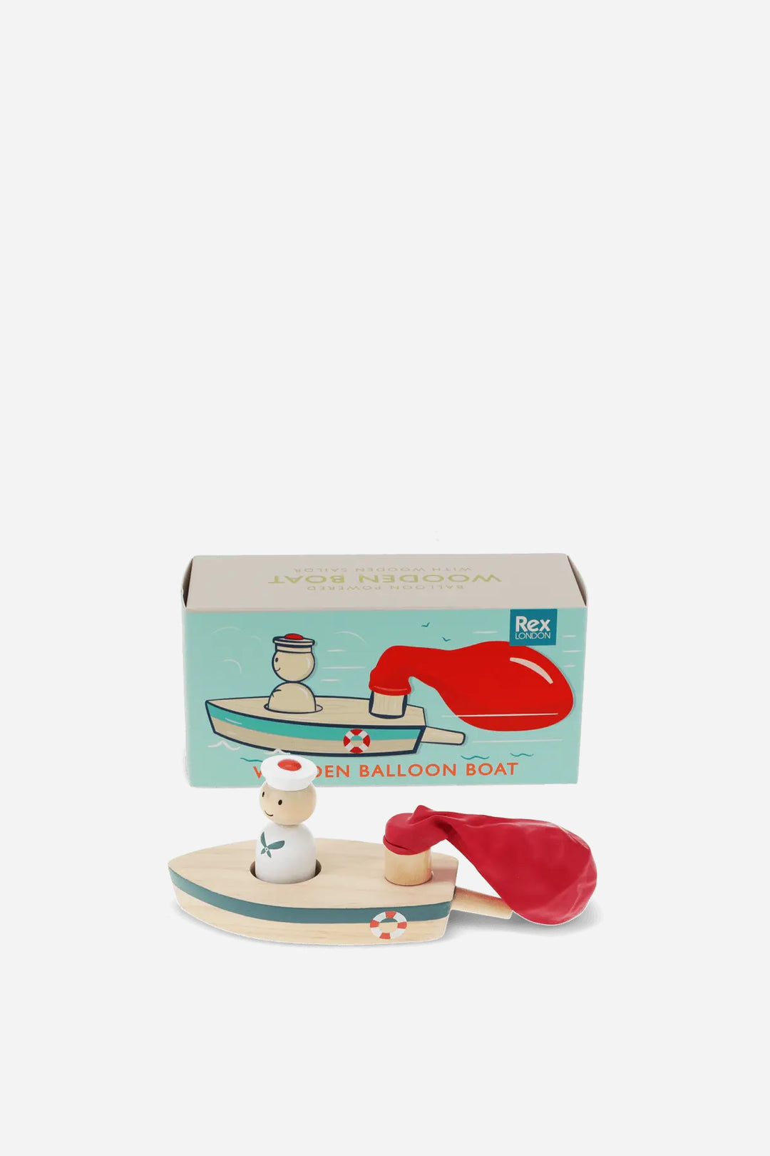featuring a small wooden boat with a white sailor figure and a red balloon boat, shown in front of its light blue and beige packaging box.