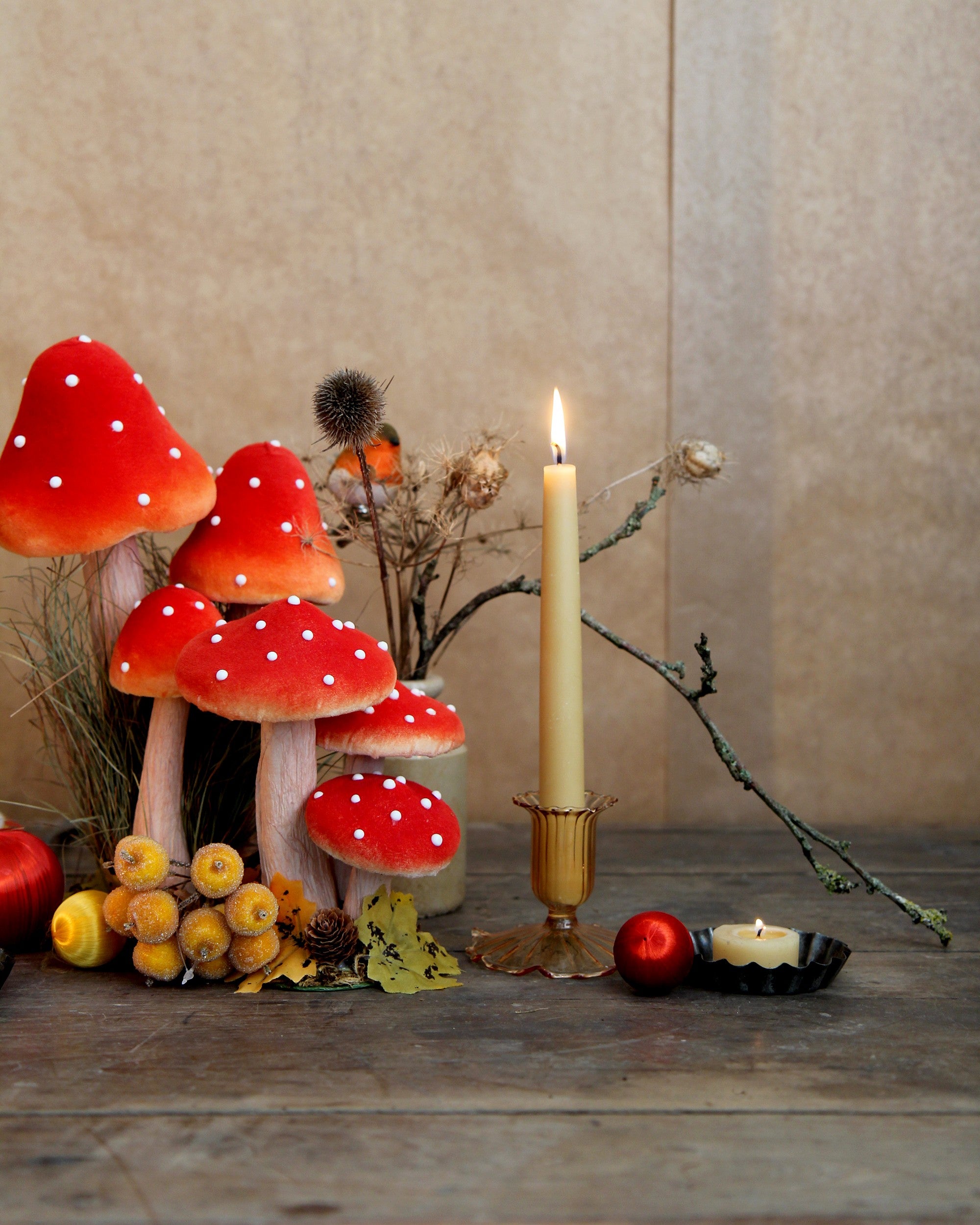 whimsical woodland tablescape with toadstools, beeswax candles and festive decorations