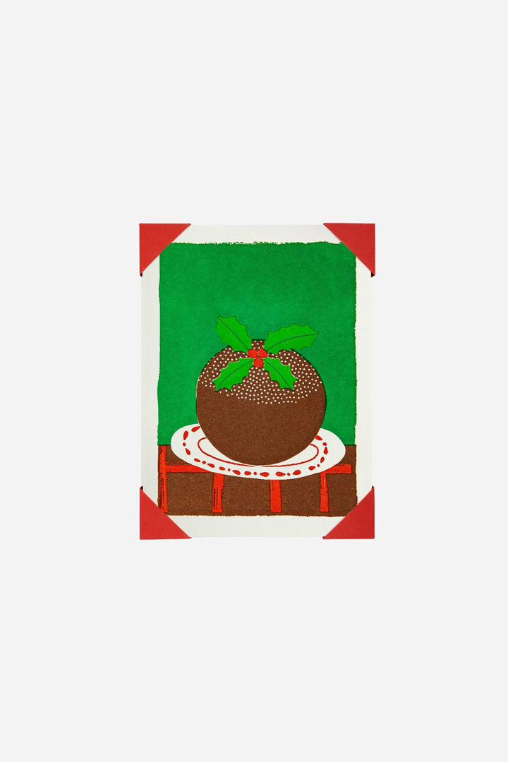 Decorative card with a Christmas pudding design on a green background